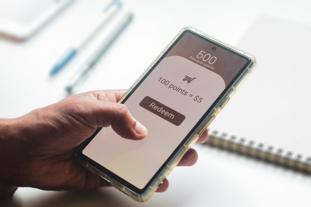Man redeeming rewards points on his mobile phone.